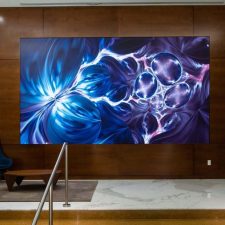 A video wall in a lobby displaying a beautiful blue-violet image.
