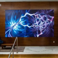 A video wall in a lobby displaying a beautiful blue-violet image.
